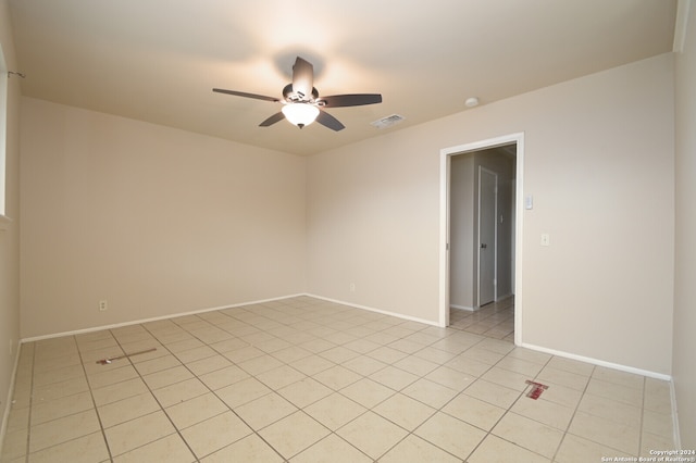 empty room with light tile patterned floors and ceiling fan