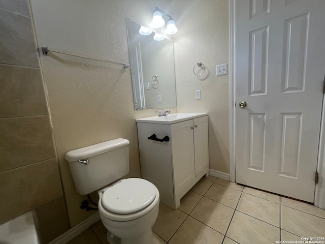 bathroom featuring vanity, toilet, and tile patterned flooring