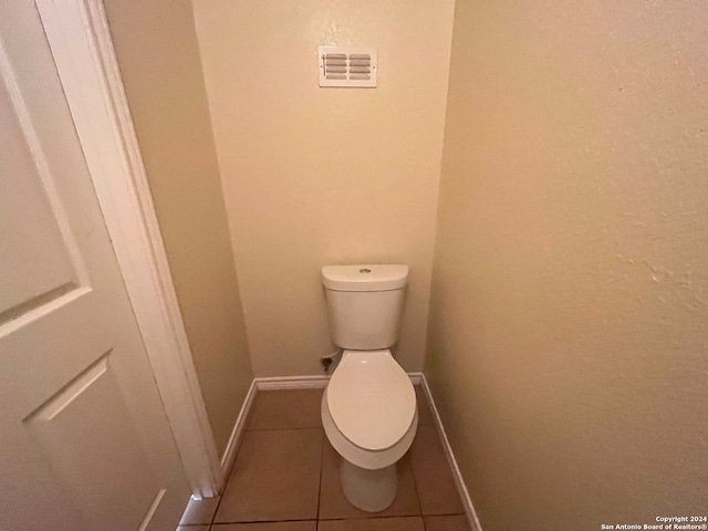 bathroom with toilet and tile patterned flooring