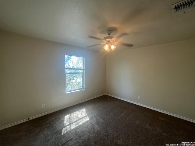 carpeted empty room featuring ceiling fan