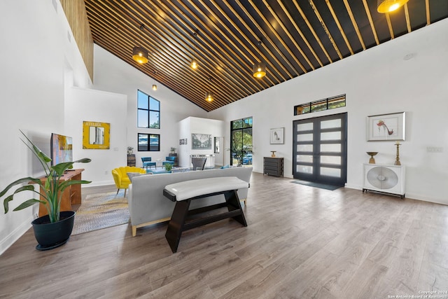 interior space featuring light hardwood / wood-style flooring, high vaulted ceiling, and wood ceiling