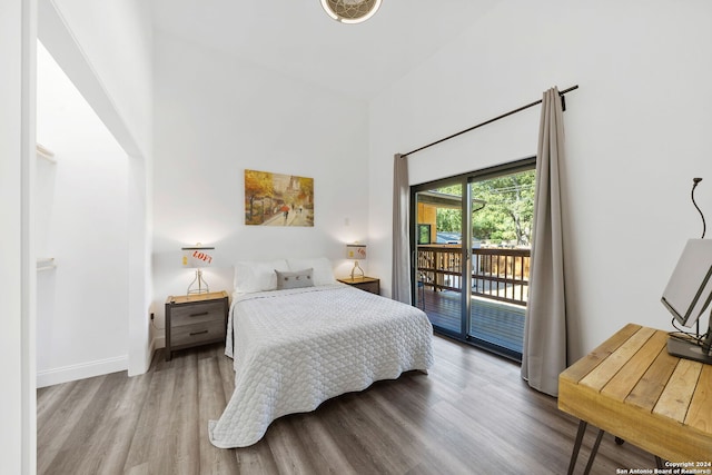 bedroom featuring access to outside and hardwood / wood-style floors