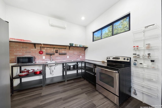 kitchen with stainless steel range with electric stovetop, a wall mounted air conditioner, and dark hardwood / wood-style floors