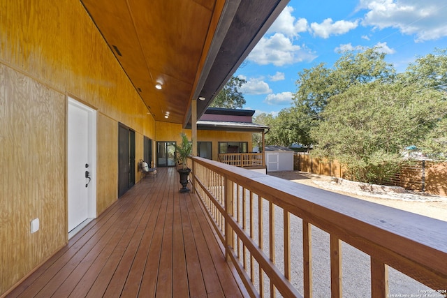 wooden deck with a storage shed