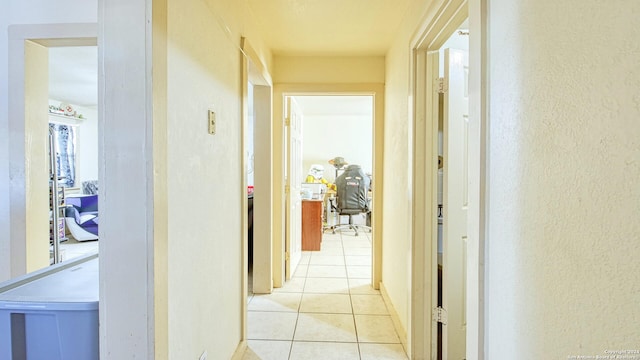 hall with light tile patterned flooring