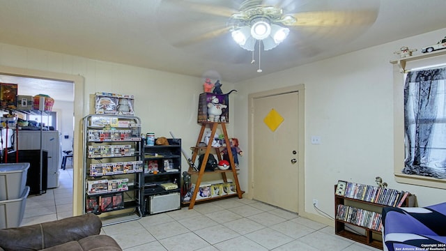 interior space with ceiling fan and light tile patterned flooring