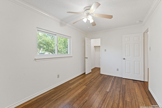 unfurnished bedroom with a textured ceiling, ceiling fan, crown molding, and dark wood-type flooring