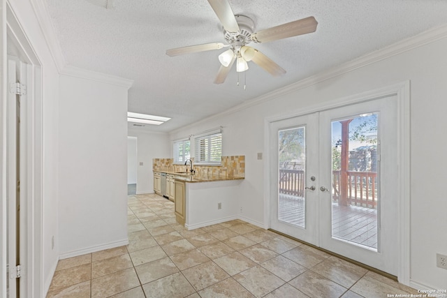 kitchen with french doors, a wealth of natural light, and crown molding