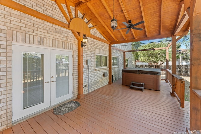 unfurnished sunroom featuring lofted ceiling with beams, a wealth of natural light, wooden ceiling, and ceiling fan