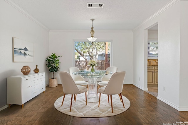 dining room with a textured ceiling, dark hardwood / wood-style flooring, and crown molding