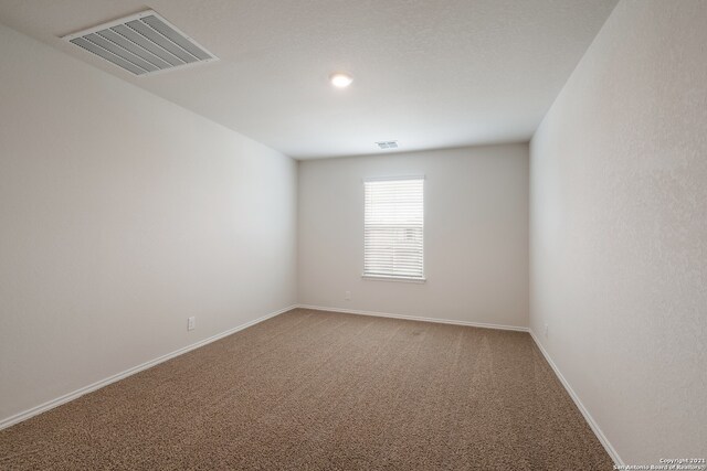 spare room featuring carpet flooring