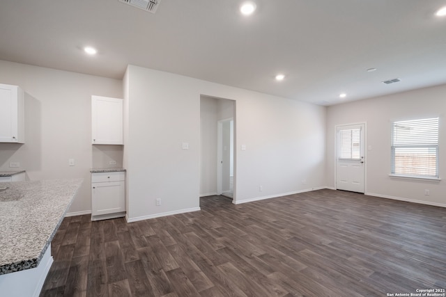 unfurnished living room with dark hardwood / wood-style flooring