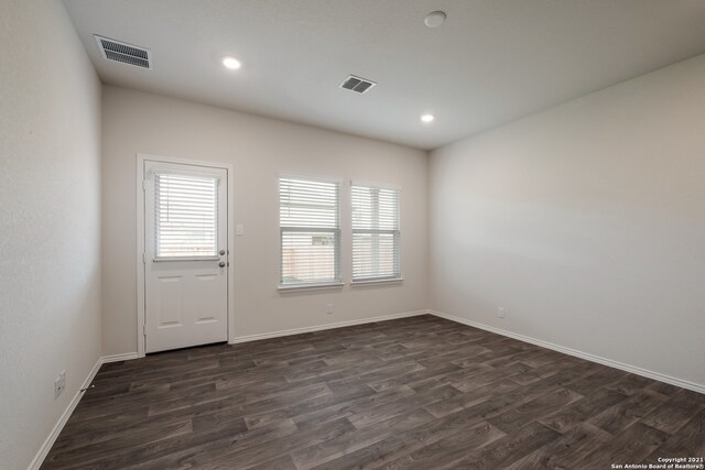 spare room featuring dark wood-type flooring