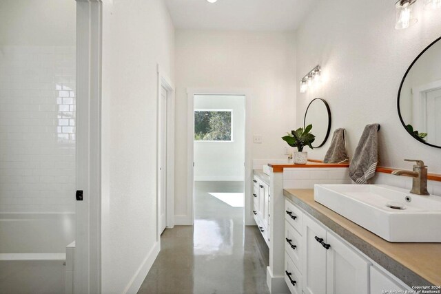 bathroom with vanity and concrete floors