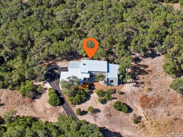 birds eye view of property featuring a wooded view