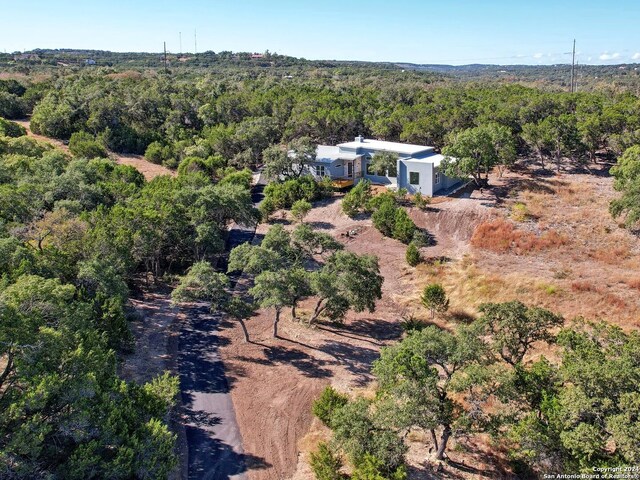 birds eye view of property with a forest view