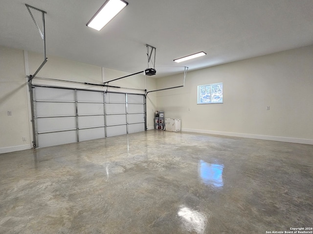 garage with a garage door opener and baseboards