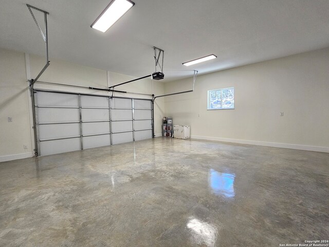 garage with baseboards and a garage door opener