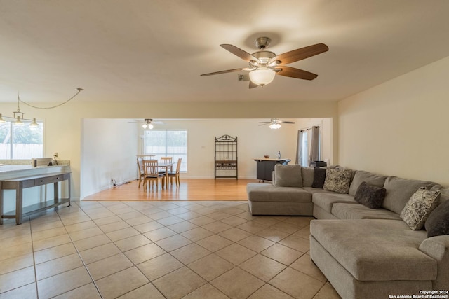 living area featuring ceiling fan and light tile patterned floors