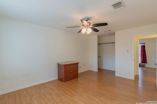 unfurnished bedroom with light hardwood / wood-style floors, a closet, and ceiling fan