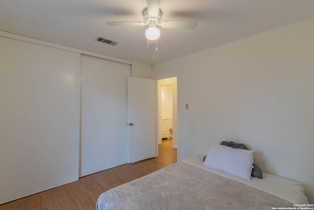 bedroom featuring a closet, ceiling fan, and light wood-type flooring