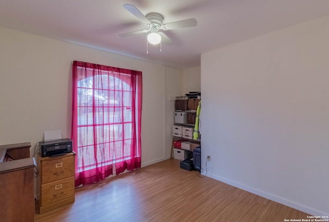 office with baseboards, a ceiling fan, and wood finished floors