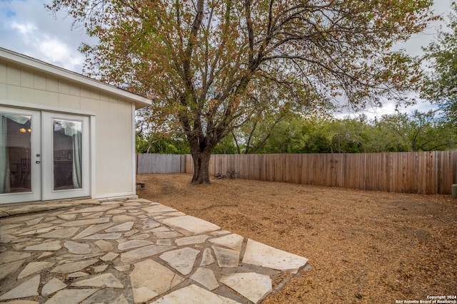 view of yard featuring a patio and french doors