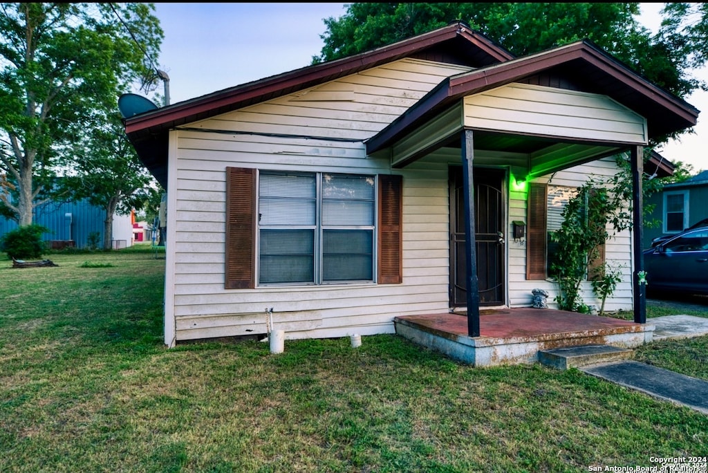 bungalow-style home with a front yard