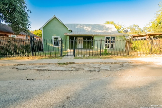 319 Vine St, San Antonio, TX 78210 - view of front of house featuring a gate, a fenced front yard, and metal roof