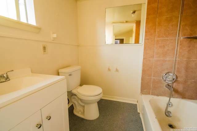 full bathroom with vanity, tiled shower / bath, and toilet