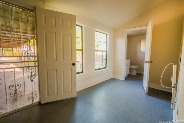 319 Vine St, San Antonio, TX 78210 - doorway to outside featuring baseboards, lofted ceiling, and dark floors