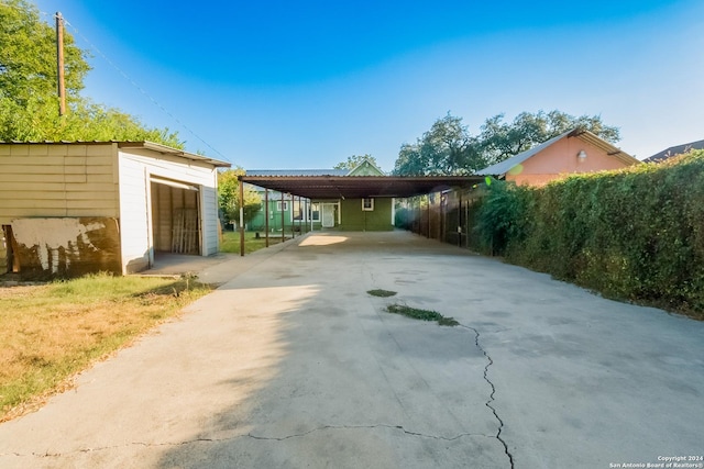 319 Vine St, San Antonio, TX 78210 - exterior space featuring driveway, an outbuilding, and a carport