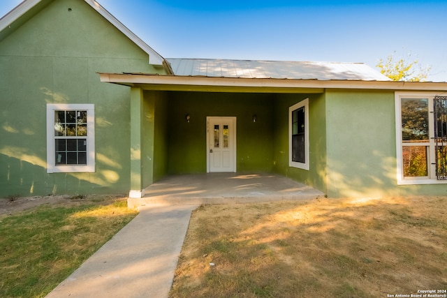 view of front of property with a patio, a front yard, and french doors