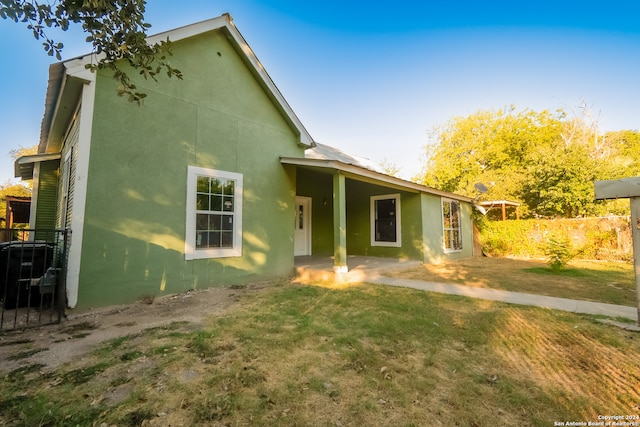 rear view of house with a lawn