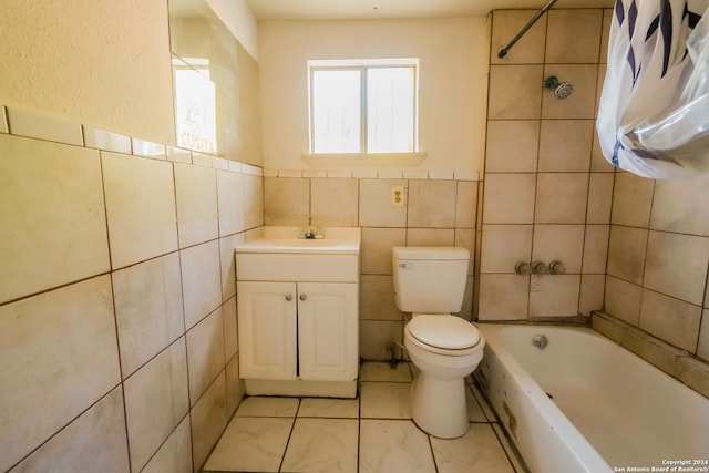 full bathroom with tile walls, vanity, shower / bath combo, and toilet