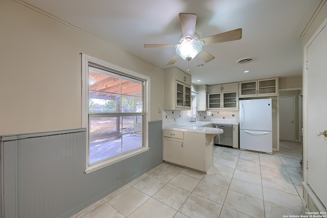 kitchen featuring white cabinetry, dishwasher, sink, ceiling fan, and white fridge