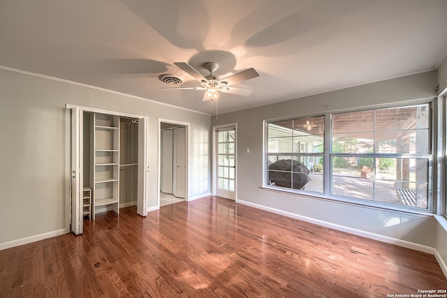 unfurnished bedroom with hardwood / wood-style floors, ceiling fan, and crown molding