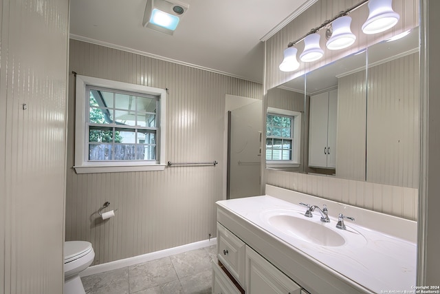 bathroom with tile patterned floors, vanity, toilet, and a wealth of natural light