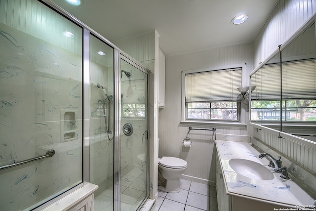 bathroom with tile patterned flooring, vanity, toilet, and walk in shower