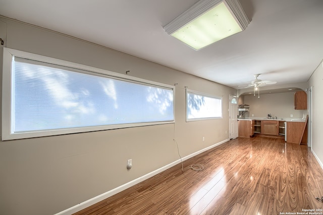 unfurnished room with light wood-type flooring and ceiling fan