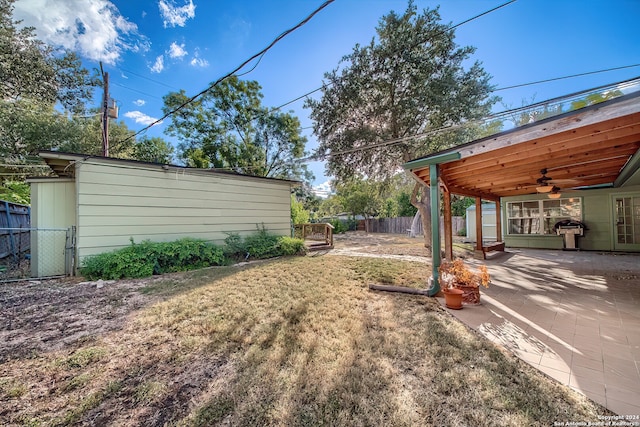 view of yard featuring a patio area and ceiling fan