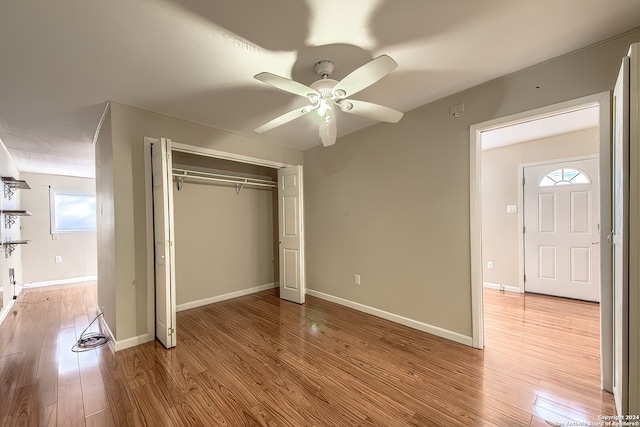 unfurnished bedroom featuring ceiling fan, a closet, and light hardwood / wood-style floors