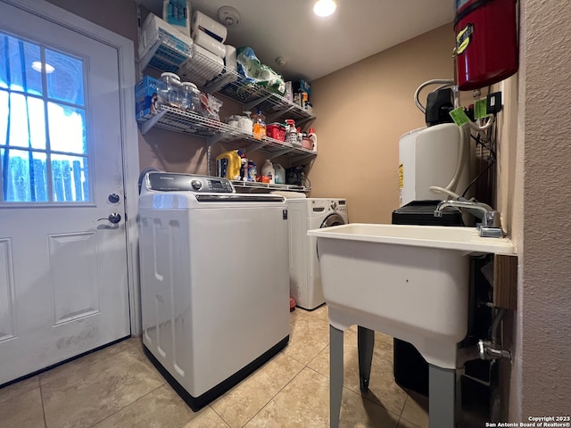 laundry area featuring independent washer and dryer and light tile patterned floors