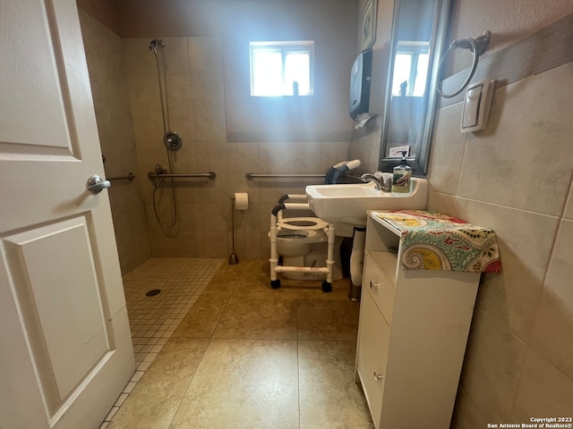 bathroom with tile patterned flooring, toilet, tile walls, and tiled shower