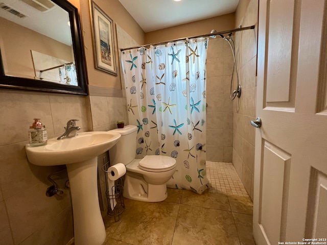 bathroom featuring tile walls, a shower with curtain, toilet, and tile patterned floors