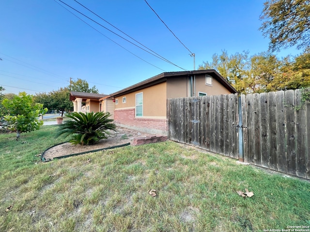 view of side of property with a yard