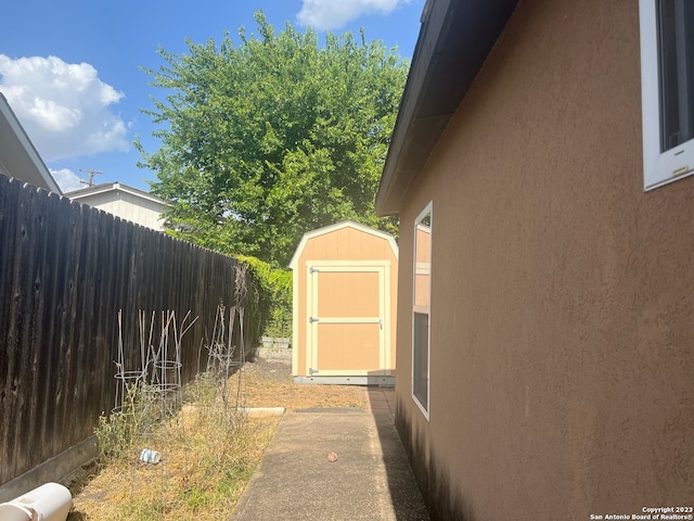 view of side of property with a shed