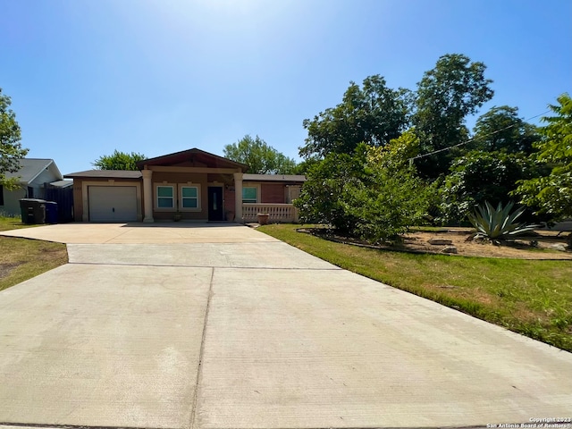 single story home featuring a front yard and a garage