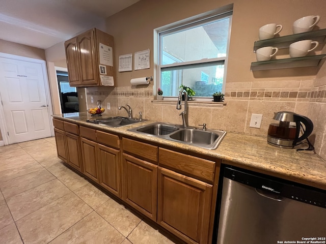 kitchen featuring light tile patterned floors, decorative backsplash, sink, and stainless steel dishwasher