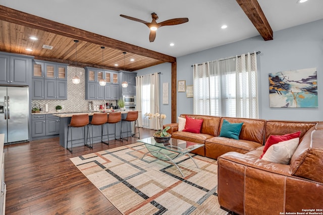 living room with beam ceiling, dark hardwood / wood-style floors, wooden ceiling, and ceiling fan